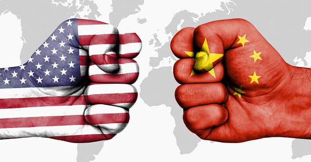 Two fists - one with US flag, one with China flag, ready to fist-bump, or strike!
